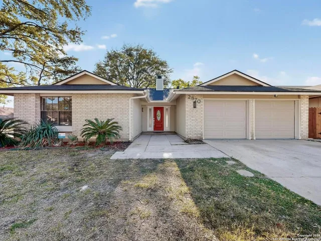 a view of a front of house with a yard and garage