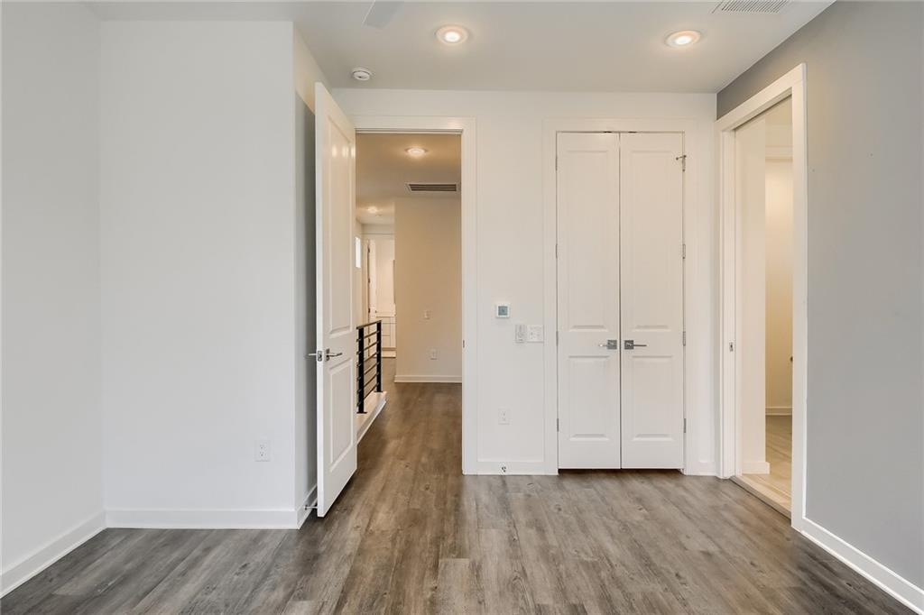 2624 Metcalfe Road, Unit 7 Austin, TX 78741 - Photo 12 of 31 a view of a hallway with wooden floor