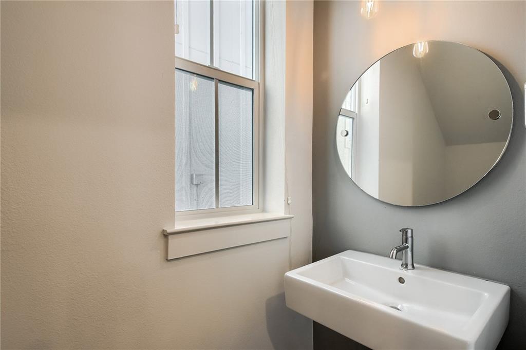 2624 Metcalfe Road, Unit 7 Austin, TX 78741 - Photo 23 of 31 a bathroom with a sink and a mirror