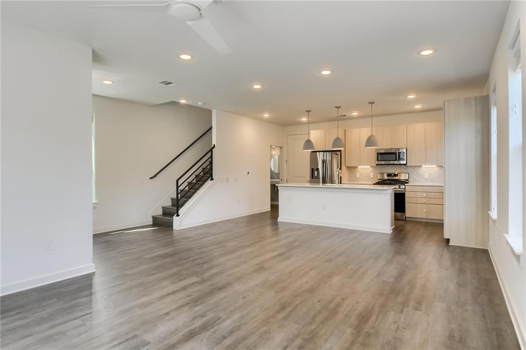 2624 Metcalfe Road, Unit 7 Austin, TX 78741 - Photo 29 of 31 a view of kitchen view wooden floor and stainless steel appliances