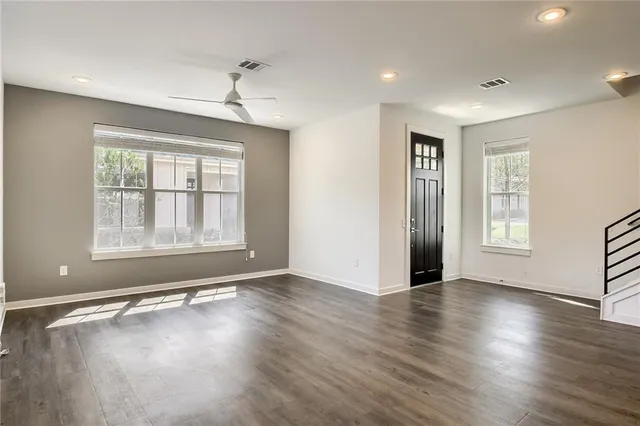 a view of kitchen view wooden floor and stainless steel appliances