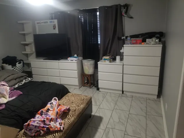 a bedroom with a bed and a television