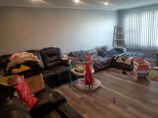 a living room with furniture chess board and a window