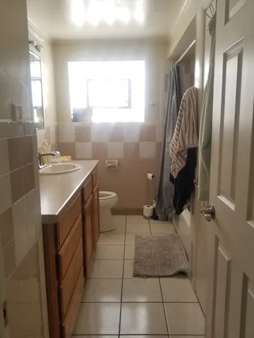 a bathroom with a sink a toilet and a shower