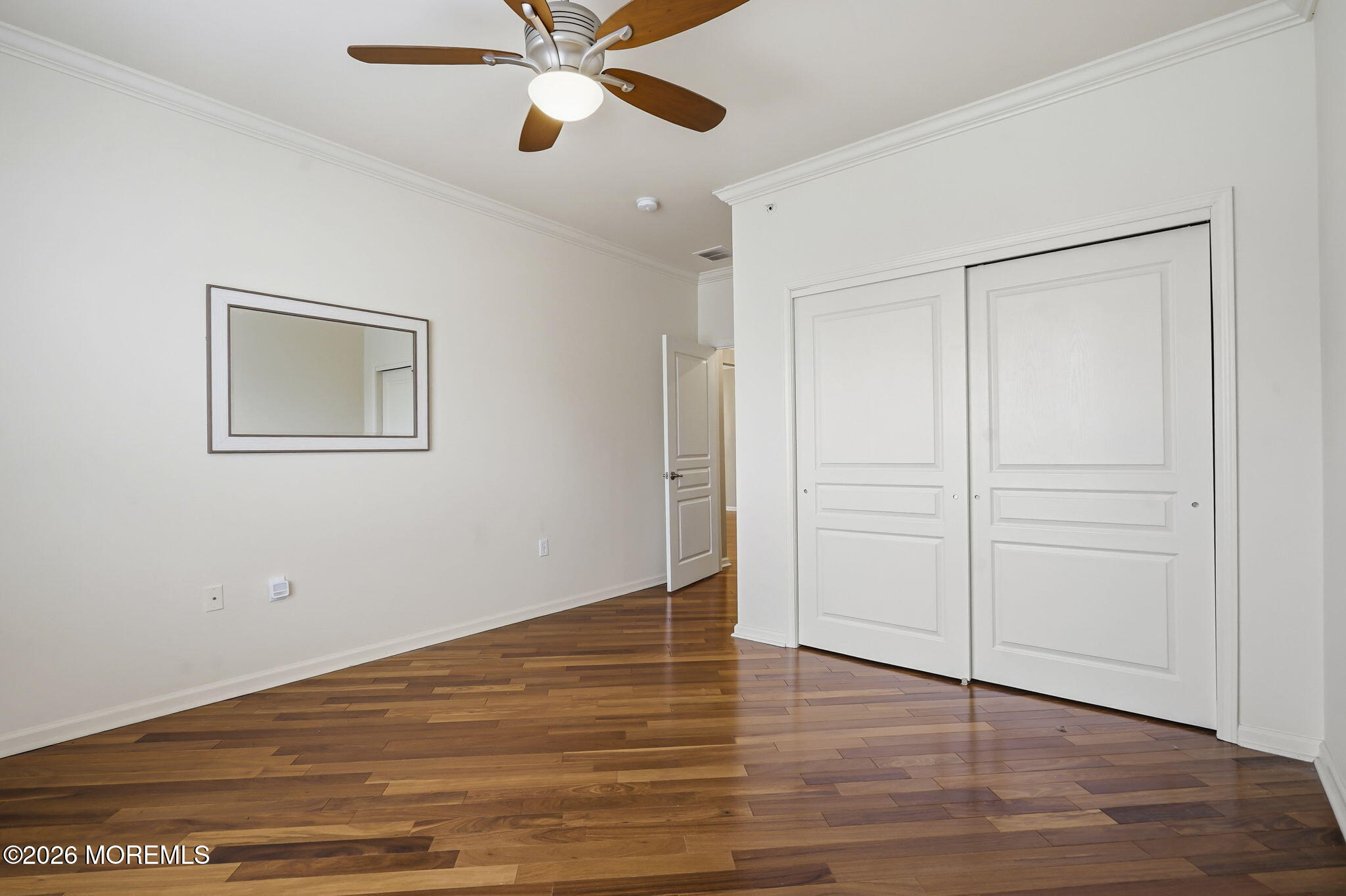106 Potts Road Morganville, NJ 07751 - Photo 17 of 25 an empty room with wooden floor closet and windows
