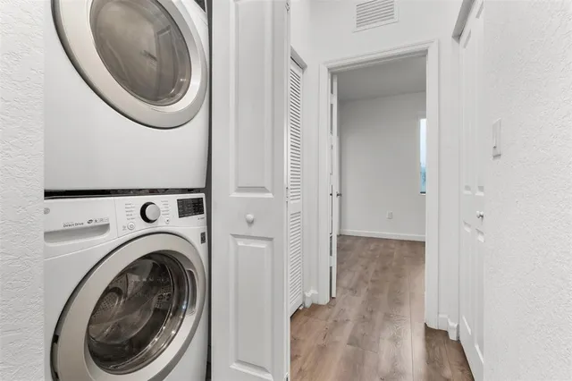 a view of a hallway with washer and dryer