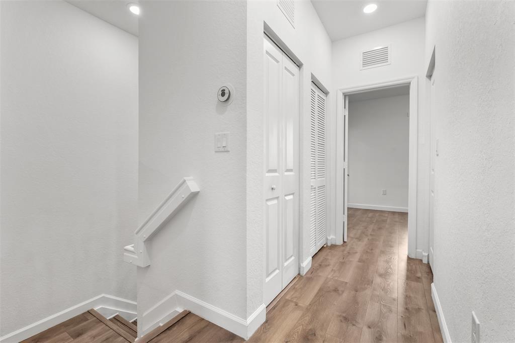 340 Northeast 208th Terrace, Unit 340 Miami, FL 33179 - Photo 14 of 38 a view of a hallway with wooden floor