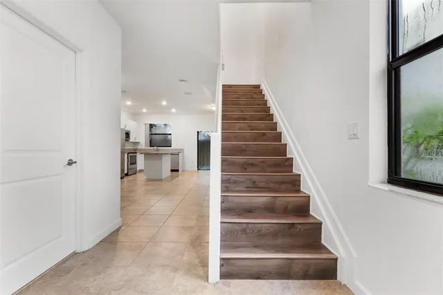 a backyard of a house with table and chairs