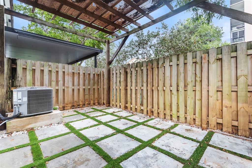 340 Northeast 208th Terrace, Unit 340 Miami, FL 33179 - Photo 32 of 38 a backyard of a house with table and chairs