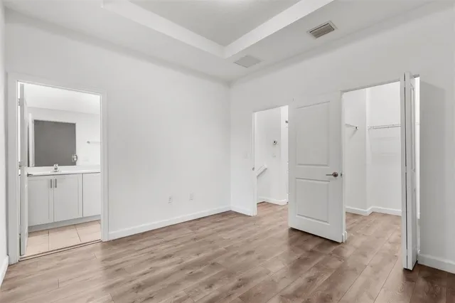 wooden floor with white walls