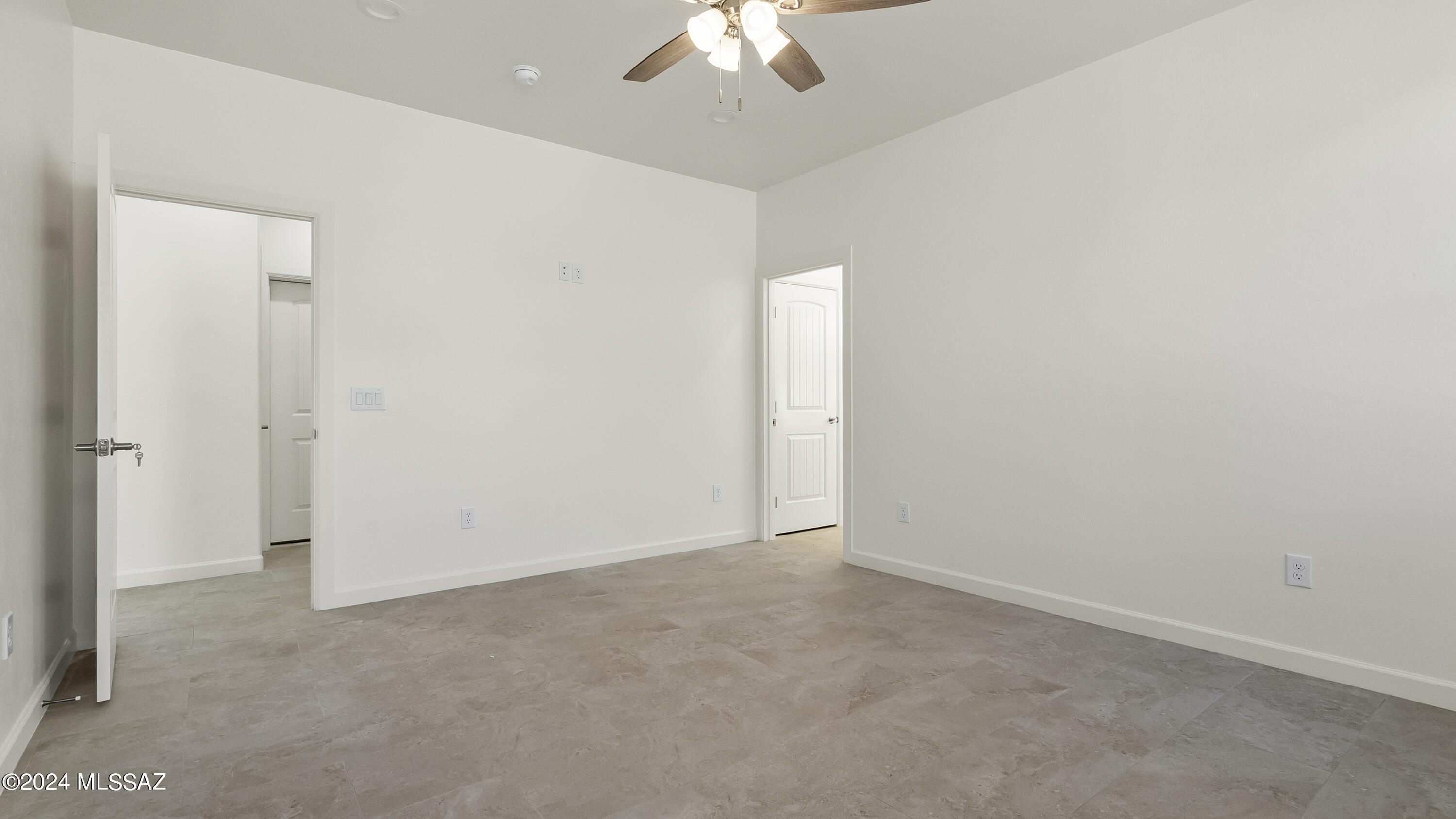 1817 Vereda Iberia Rio Rico, AZ 85648 - Photo 21 of 25 an empty room with a ceiling fan and a window