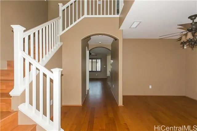 a view of a hallway with wooden floor and staircase