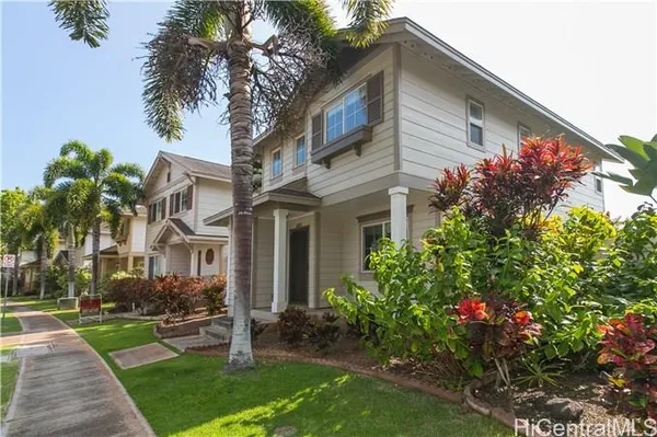 a front view of a house with a garden