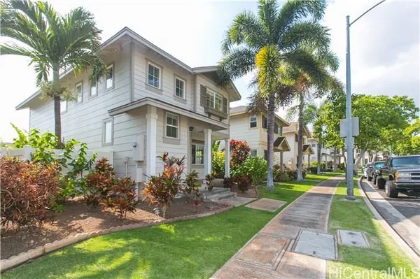 a front view of a house with garden