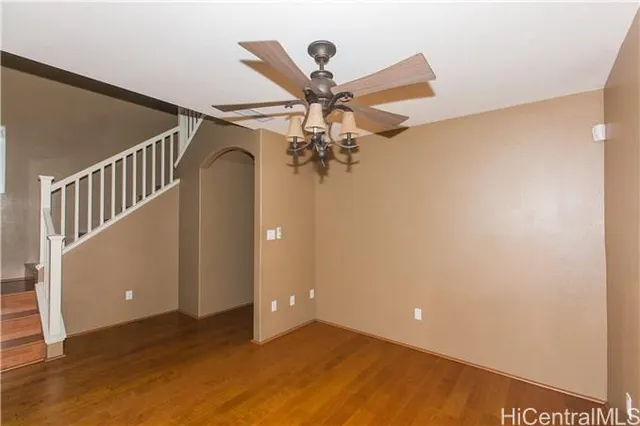 a view of a livingroom with a ceiling fan and window