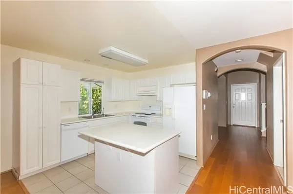 a kitchen with a refrigerator a sink and a stove
