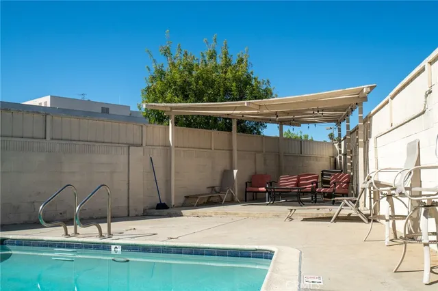 a backyard of a house with table and chairs