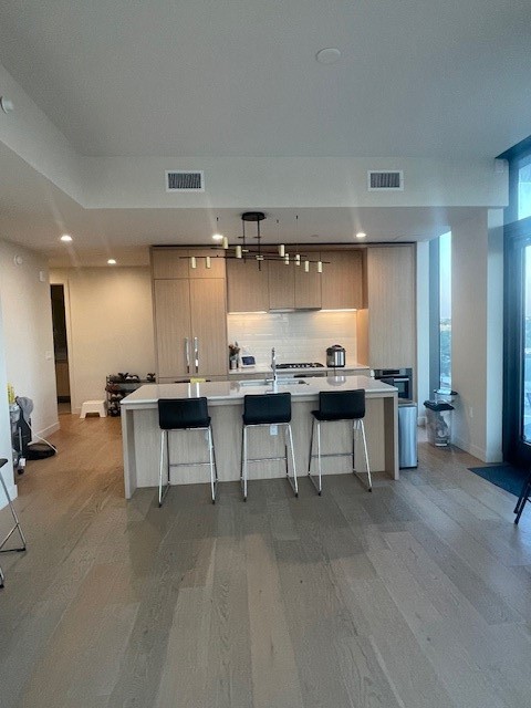 44 East Avenue, Unit 1210 Austin, TX 78701 - Photo 11 of 12 a view of a kitchen with dining room and wooden floor