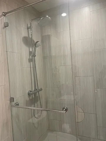a bathroom with a shower and a sink