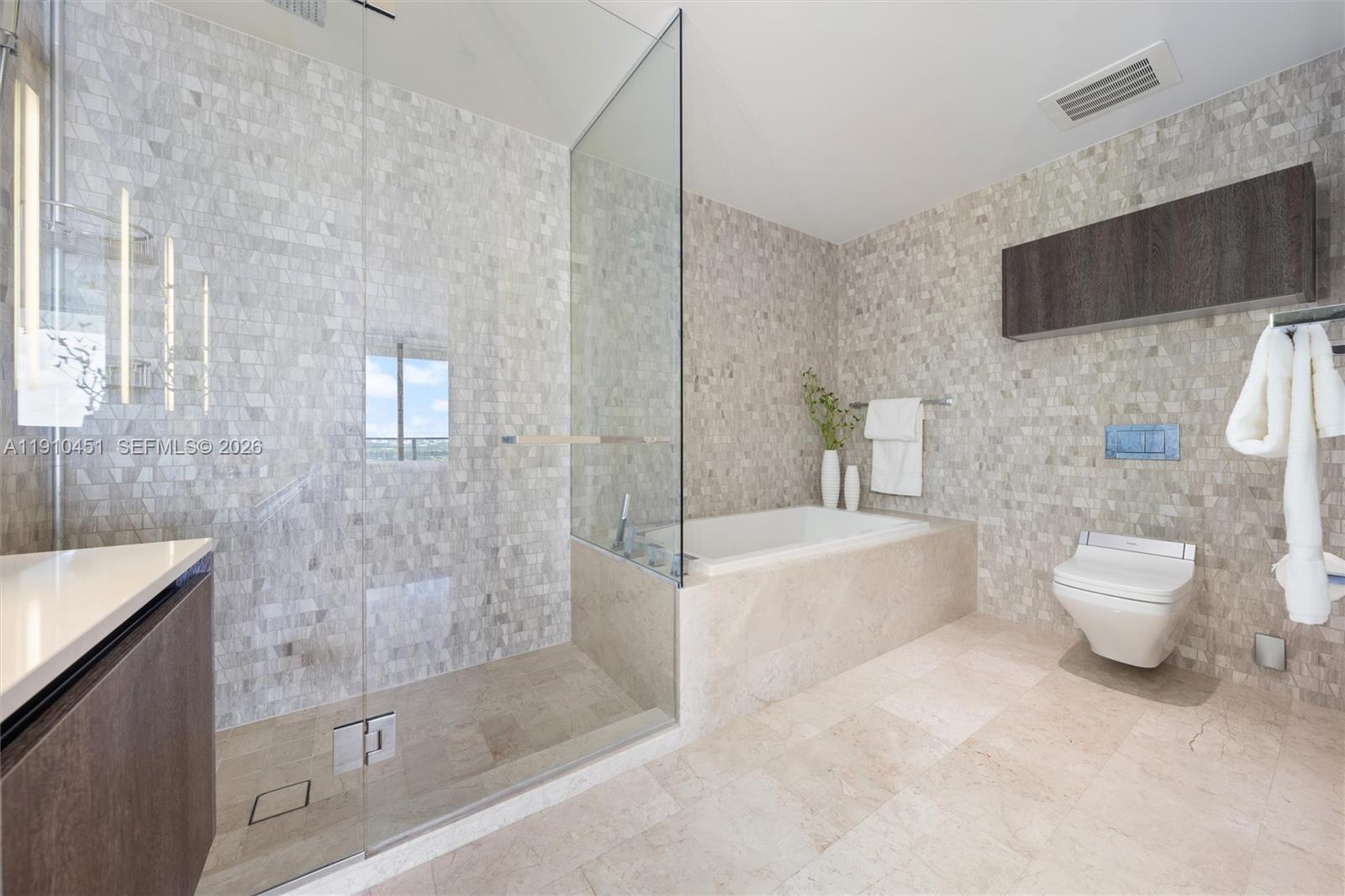 88 Southwest 7th Street, Unit 2602 Miami, FL 33130 - Photo 12 of 28 a bathroom with a sink a toilet and bathtub