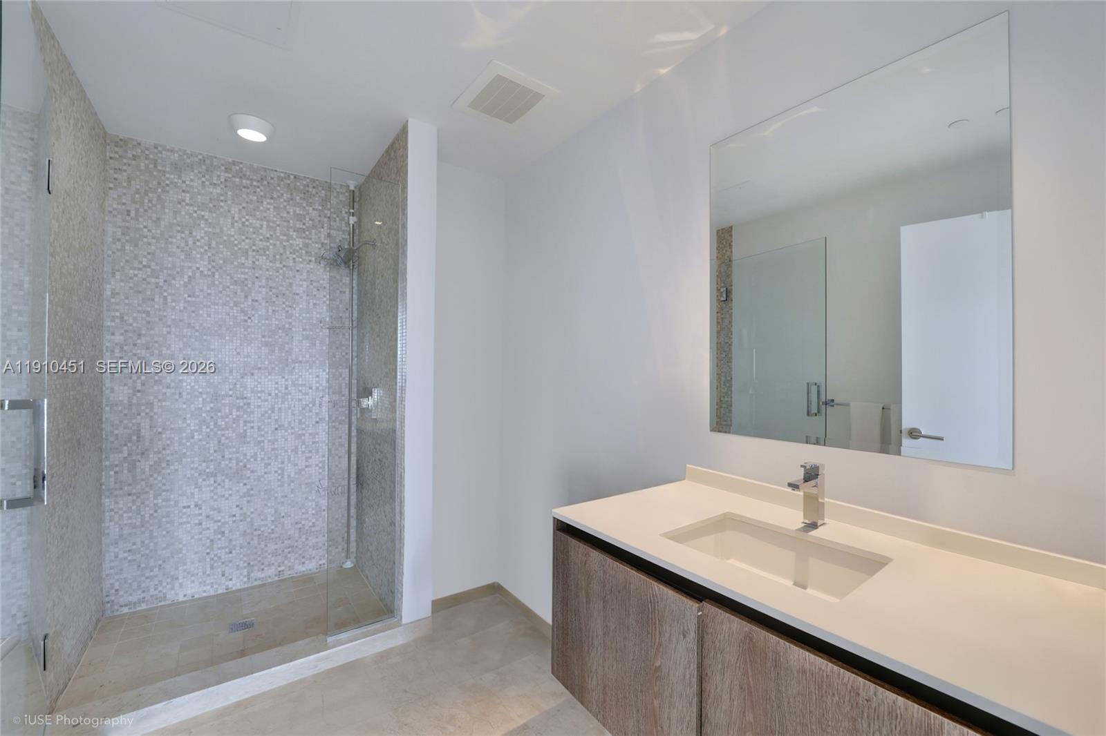 88 Southwest 7th Street, Unit 2602 Miami, FL 33130 - Photo 15 of 28 a bathroom with a sink and a mirror