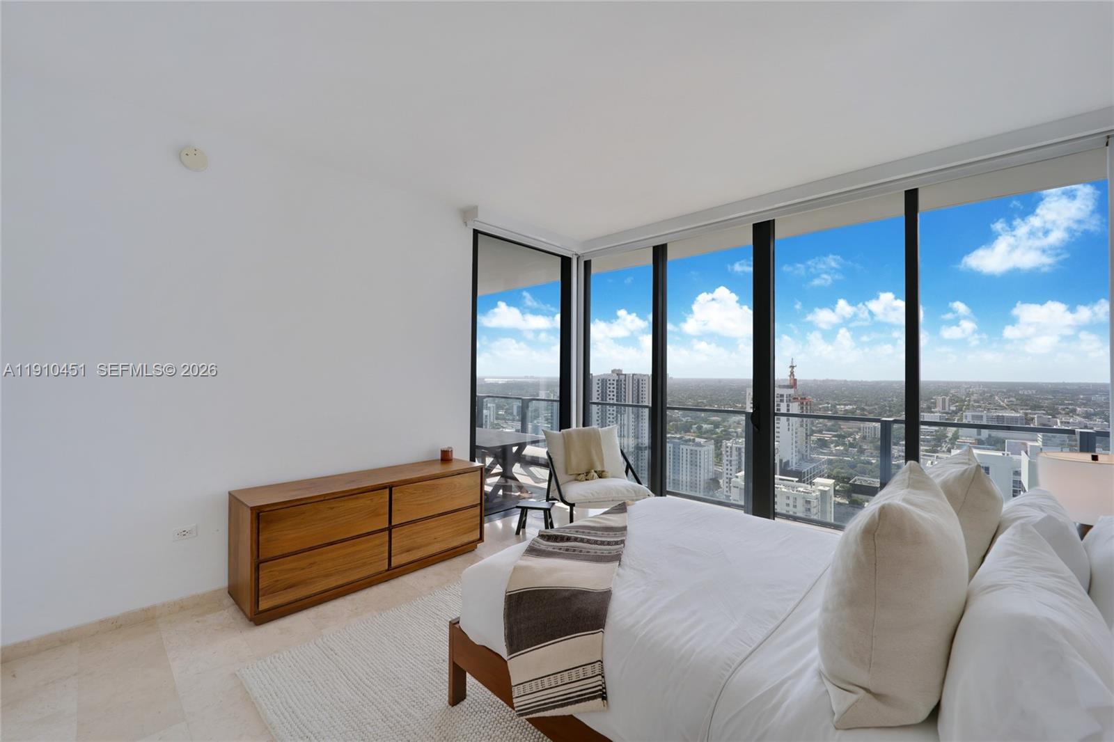 88 Southwest 7th Street, Unit 2602 Miami, FL 33130 - Photo 10 of 28 a living room with furniture and floor to ceiling windows