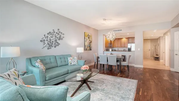 a living room with furniture a window and a dining table