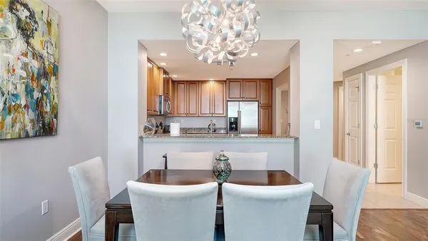 a kitchen with stainless steel appliances granite countertop a stove top oven a sink and dishwasher a refrigerator with wooden cabinets