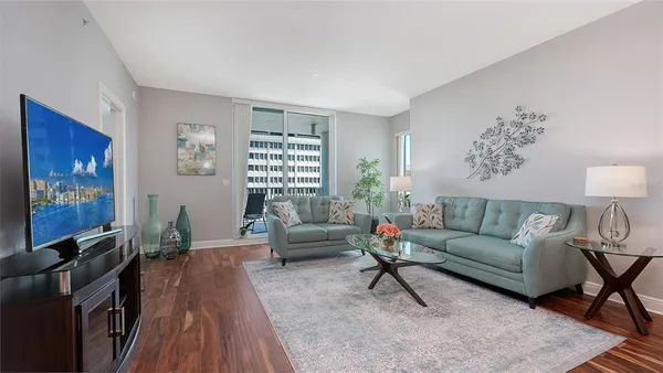 a living room with furniture flat screen tv and a fireplace