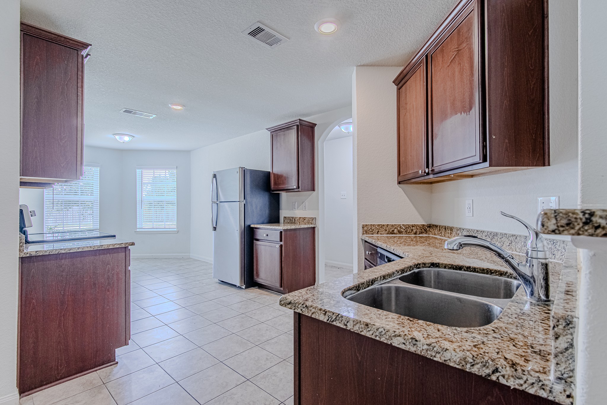 9522 Olive Stone Drive Rosharon, TX 77583 - Photo 10 of 29 a kitchen that has a sink cabinets counter space and stainless steel appliances