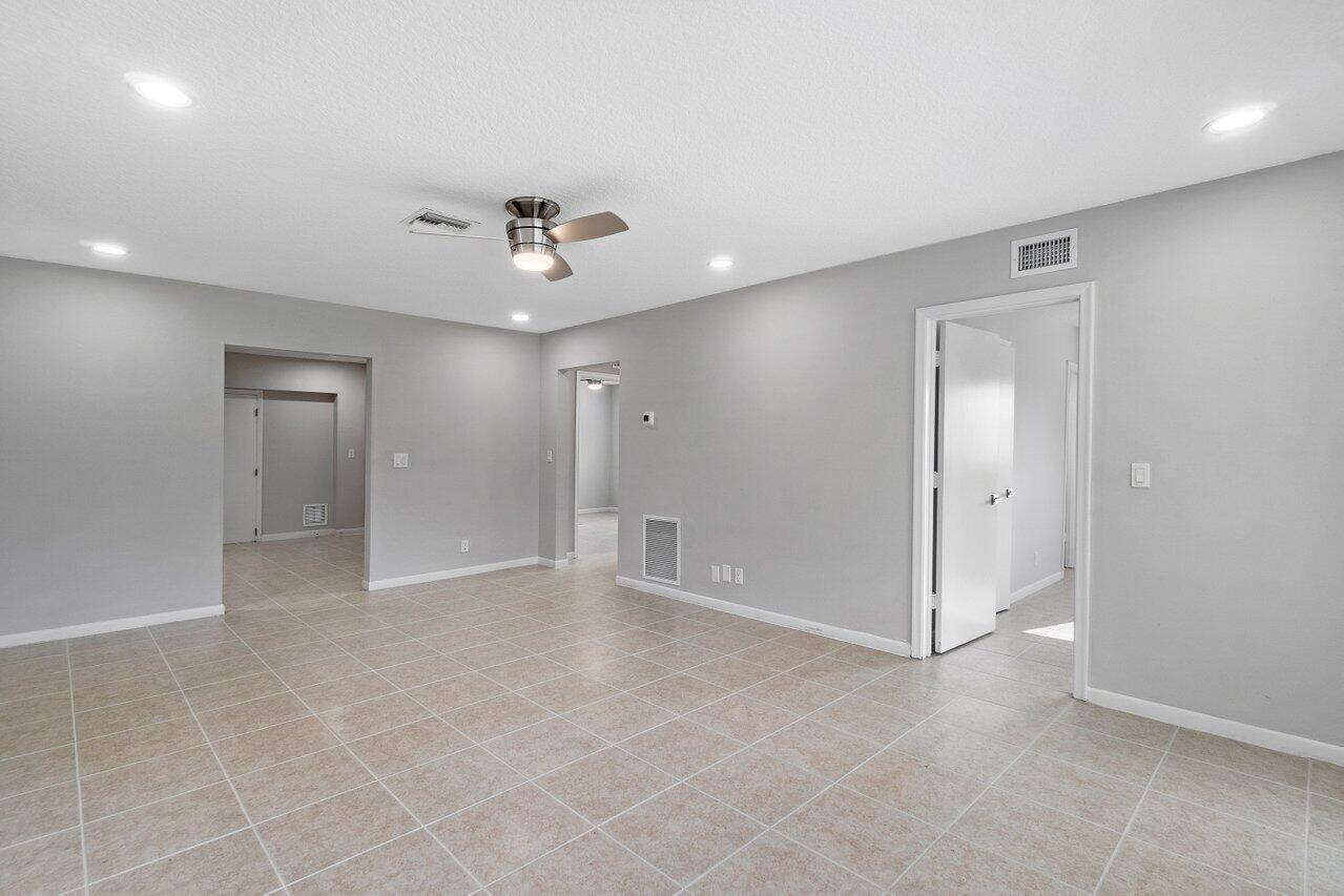 209 Southwest 6th Street, Unit 209 Boca Raton, FL 33432 - Photo 11 of 37 an empty room with fan and entrance
