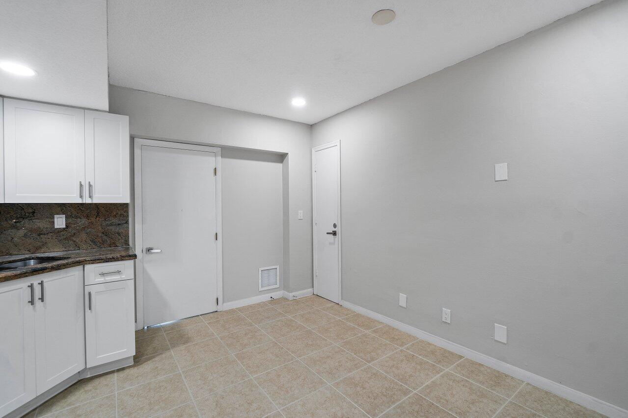 209 Southwest 6th Street, Unit 209 Boca Raton, FL 33432 - Photo 14 of 37 a bathroom with a sink and a mirror
