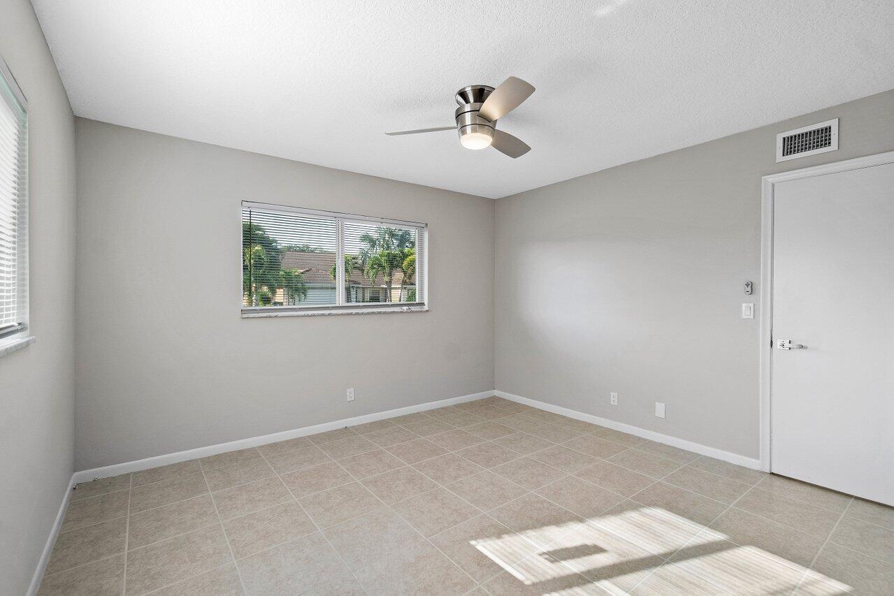 209 Southwest 6th Street, Unit 209 Boca Raton, FL 33432 - Photo 18 of 37 a view of an empty room with a window