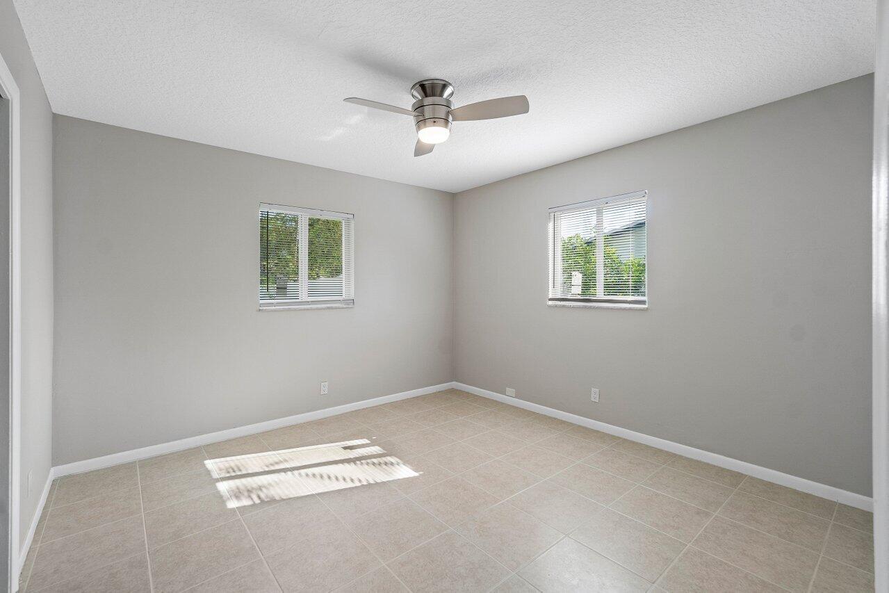 209 Southwest 6th Street, Unit 209 Boca Raton, FL 33432 - Photo 20 of 37 wooden floor in an empty room with a window