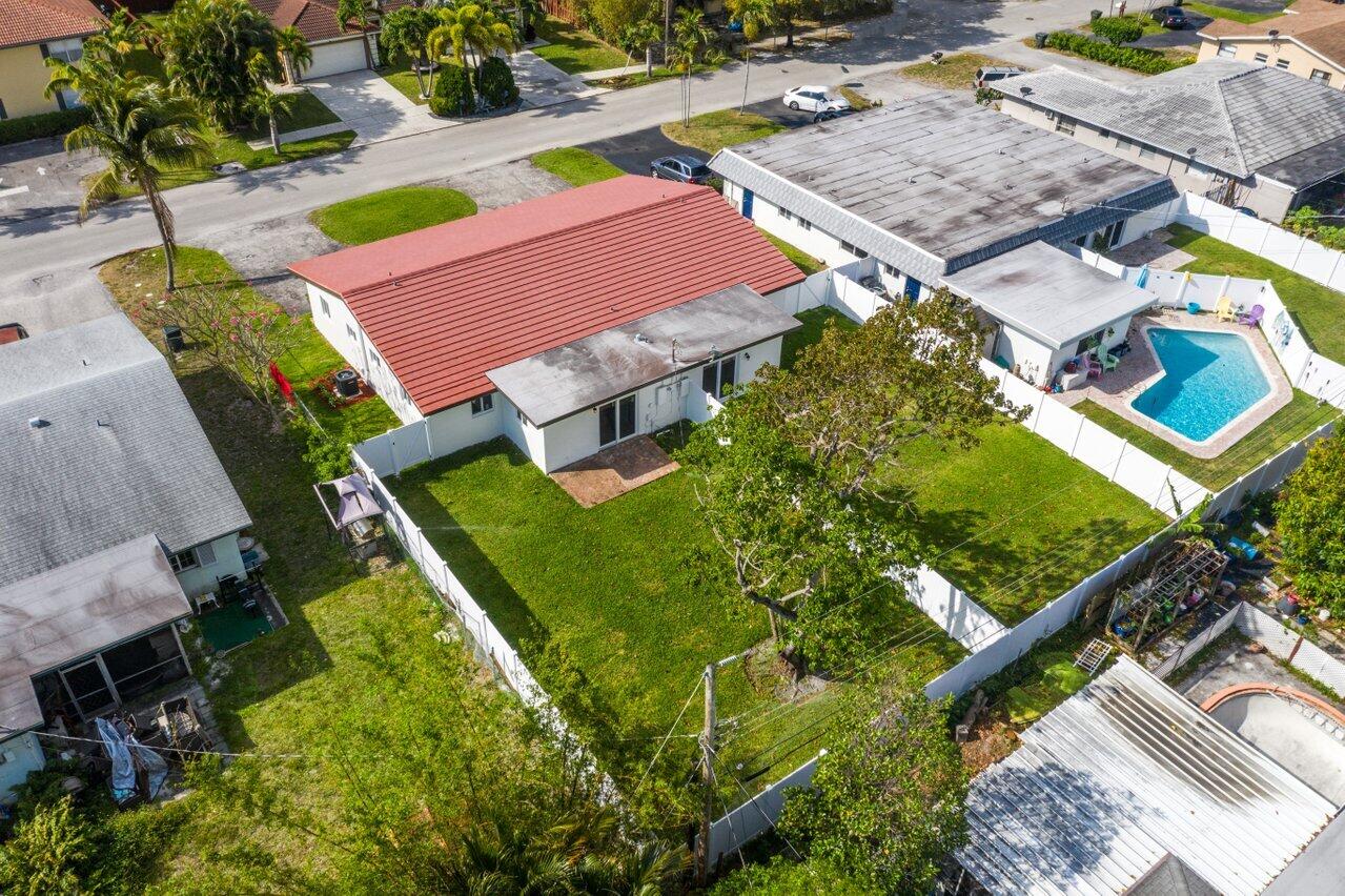 209 Southwest 6th Street, Unit 209 Boca Raton, FL 33432 - Photo 27 of 37 an aerial view of a house with a garden and swimming pool