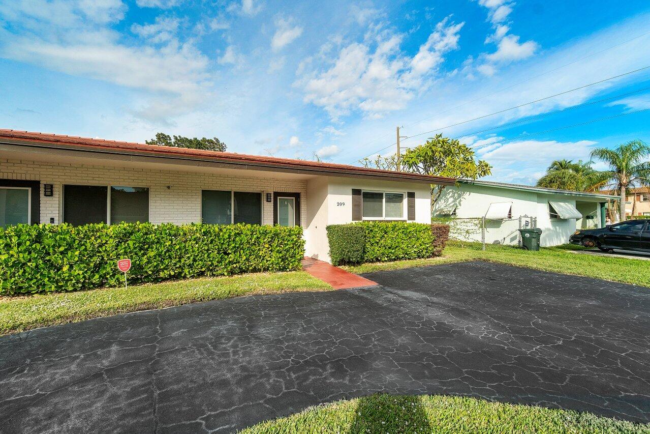 209 Southwest 6th Street, Unit 209 Boca Raton, FL 33432 - Photo 3 of 37 a view of a house with backyard and garden