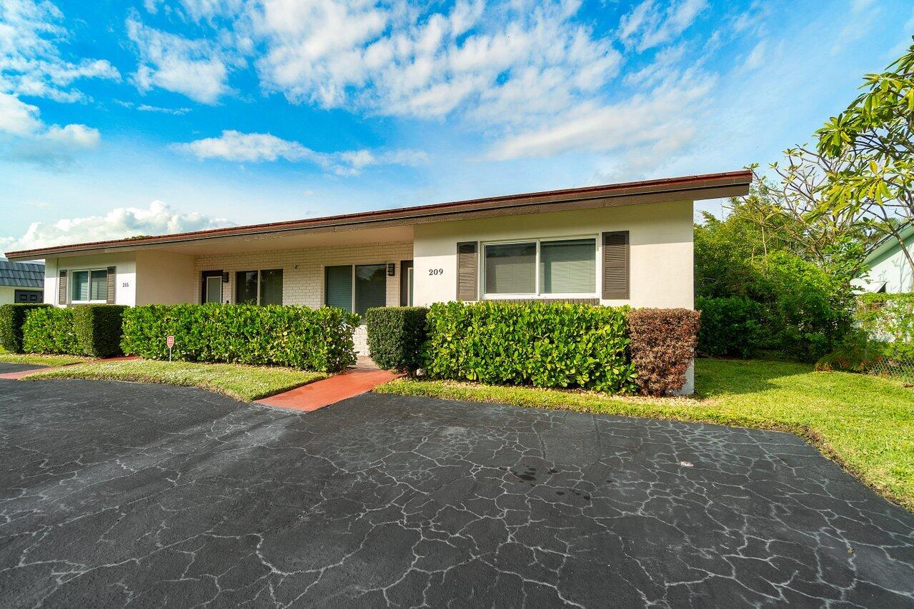 209 Southwest 6th Street, Unit 209 Boca Raton, FL 33432 - Photo 5 of 37 a front view of house with yard and green space