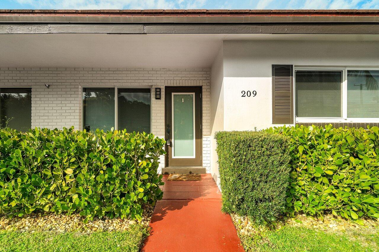 209 Southwest 6th Street, Unit 209 Boca Raton, FL 33432 - Photo 9 of 37 a view of entrance door of the house