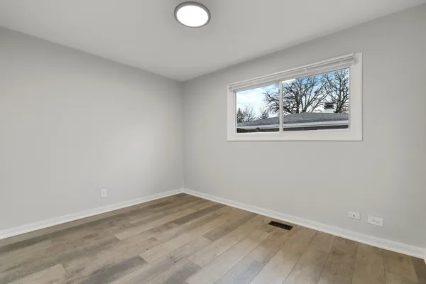 a view of a small space with wooden floor