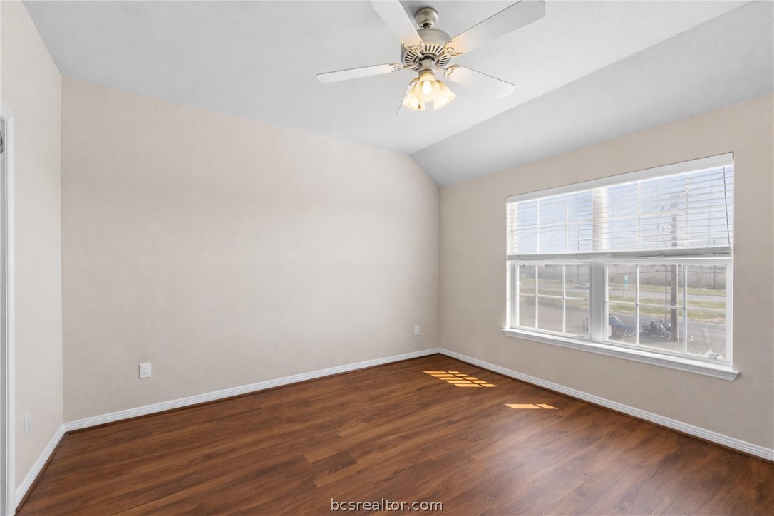1198 Jones-Butler Road, Unit 3005 College Station, TX 77840 - Photo 14 of 24 an empty room with wooden floor fan and windows