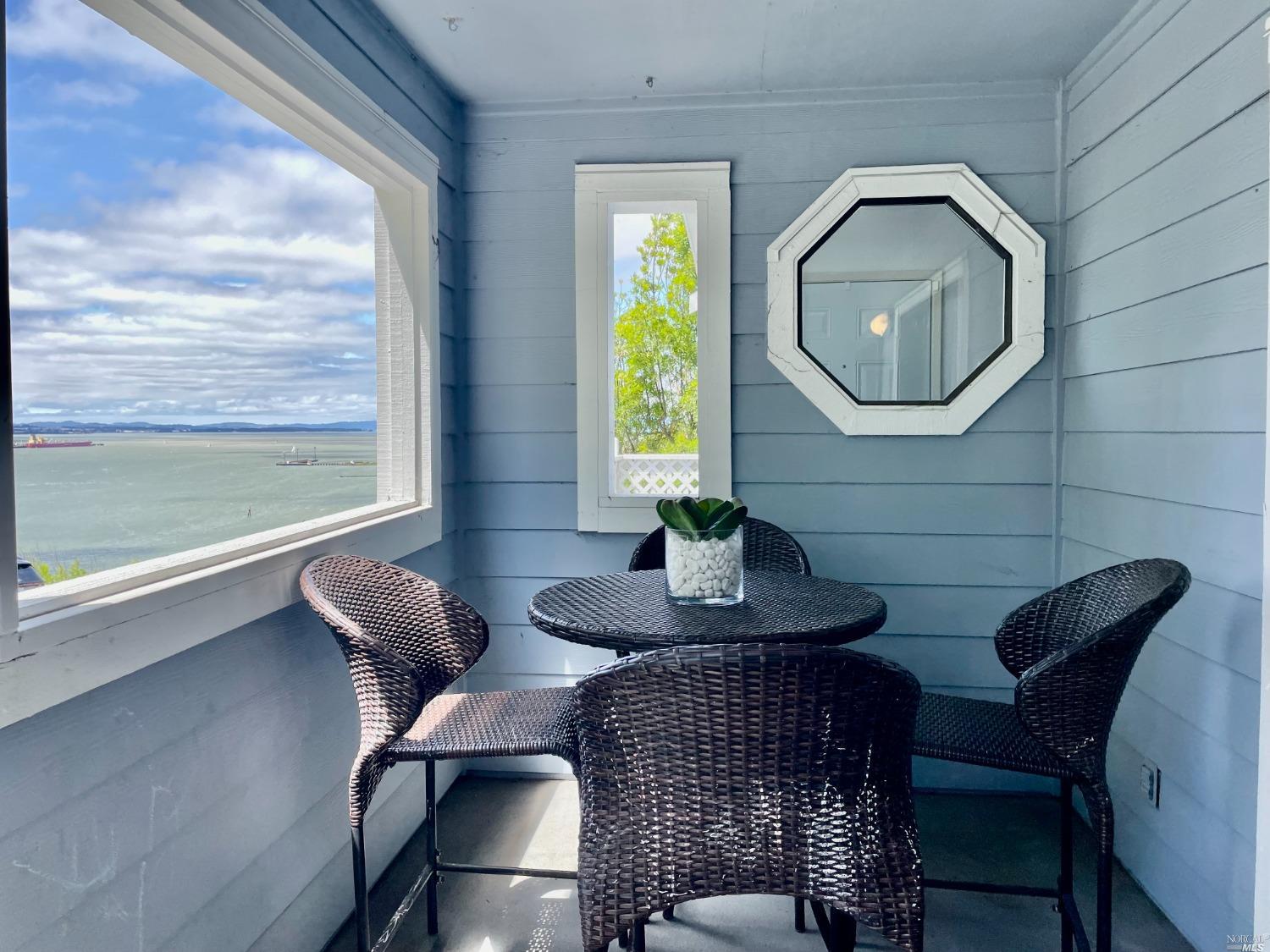 a view of a dining room with furniture and a large window
