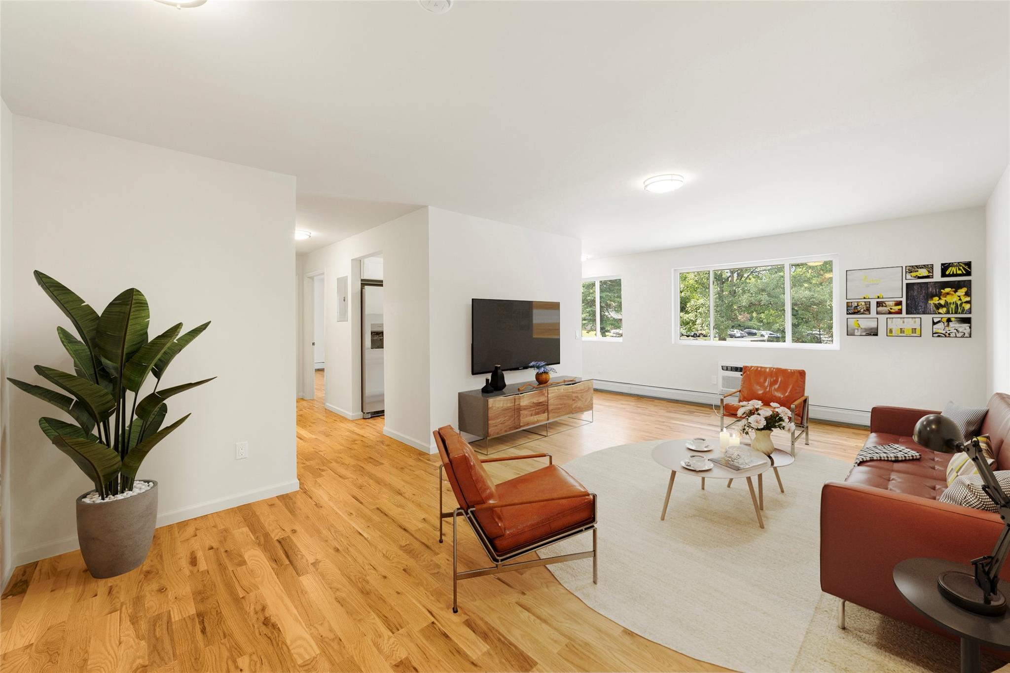 a living room with furniture or couch and a potted plant