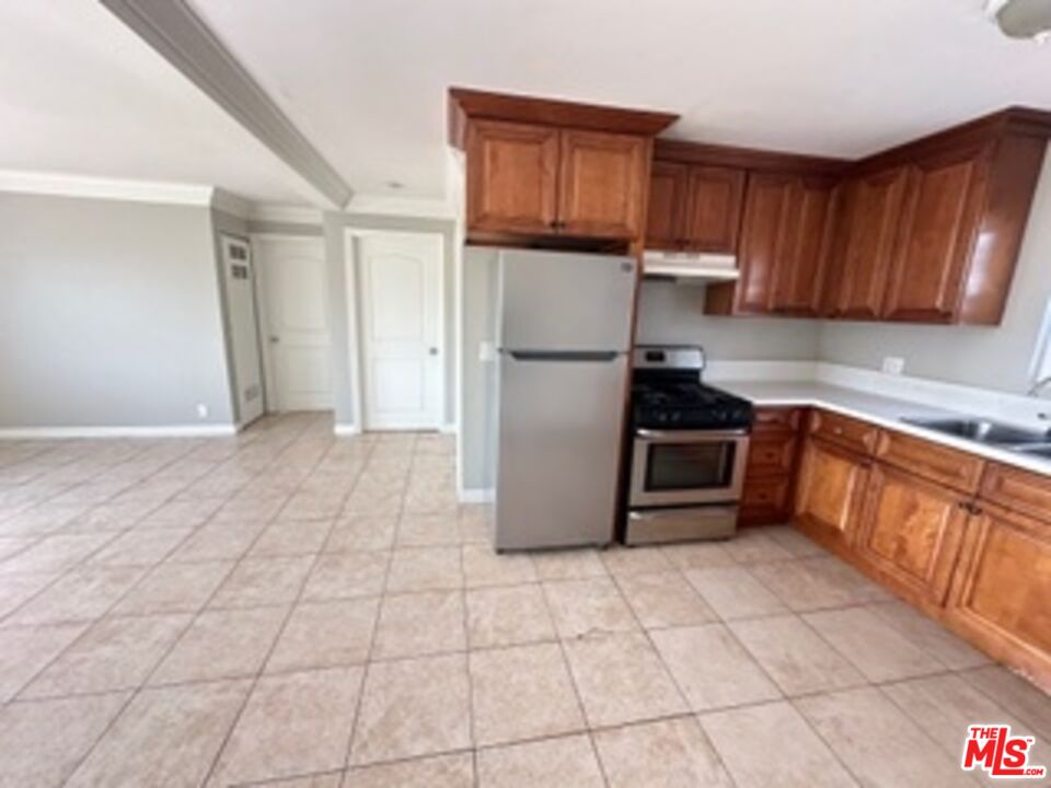 6137 Toltec Way, Unit 7 Los Angeles, CA 90042 - Photo 3 of 8 a kitchen with a sink a stove and refrigerator