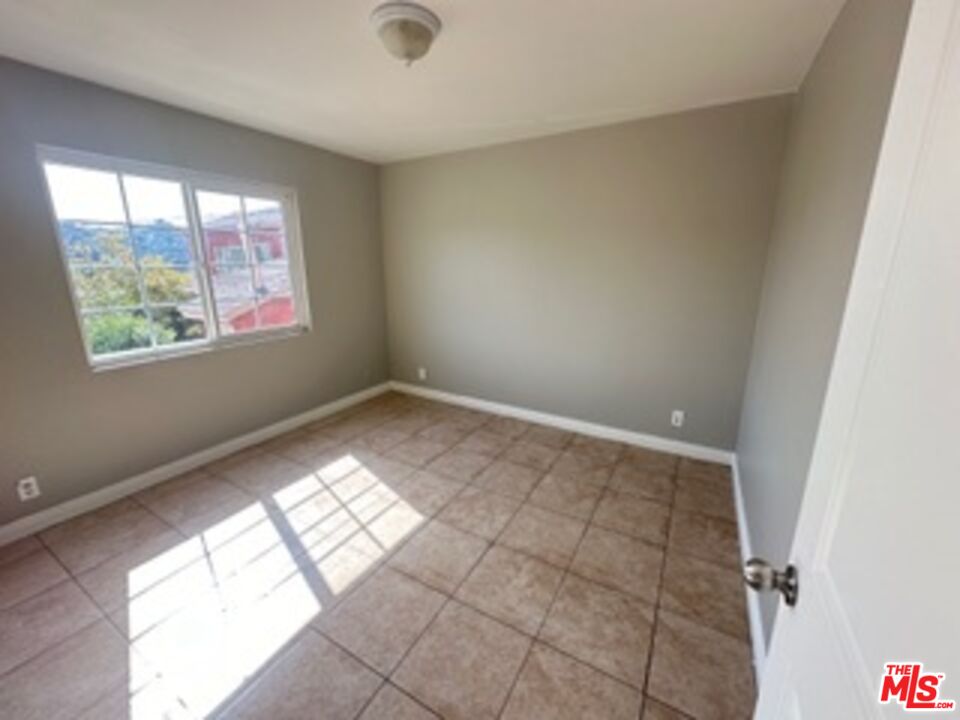 6137 Toltec Way, Unit 7 Los Angeles, CA 90042 - Photo 7 of 8 a view of an empty room and window
