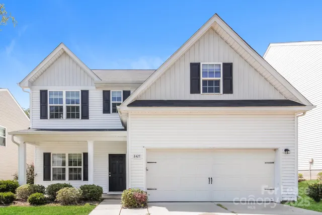 a view of a yard in front view of a house