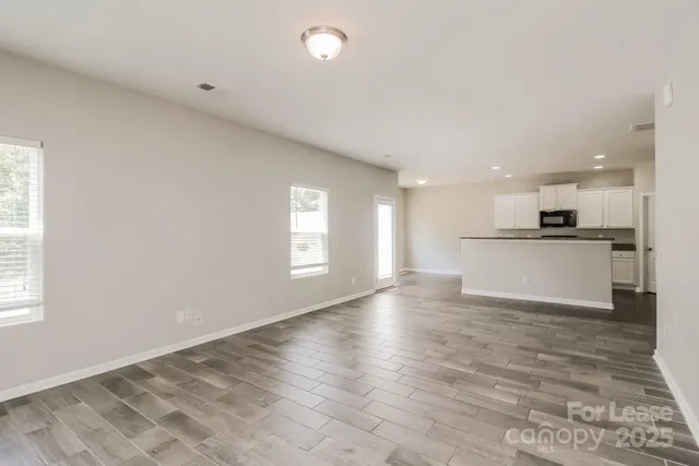 a view of kitchen with wooden floor and window