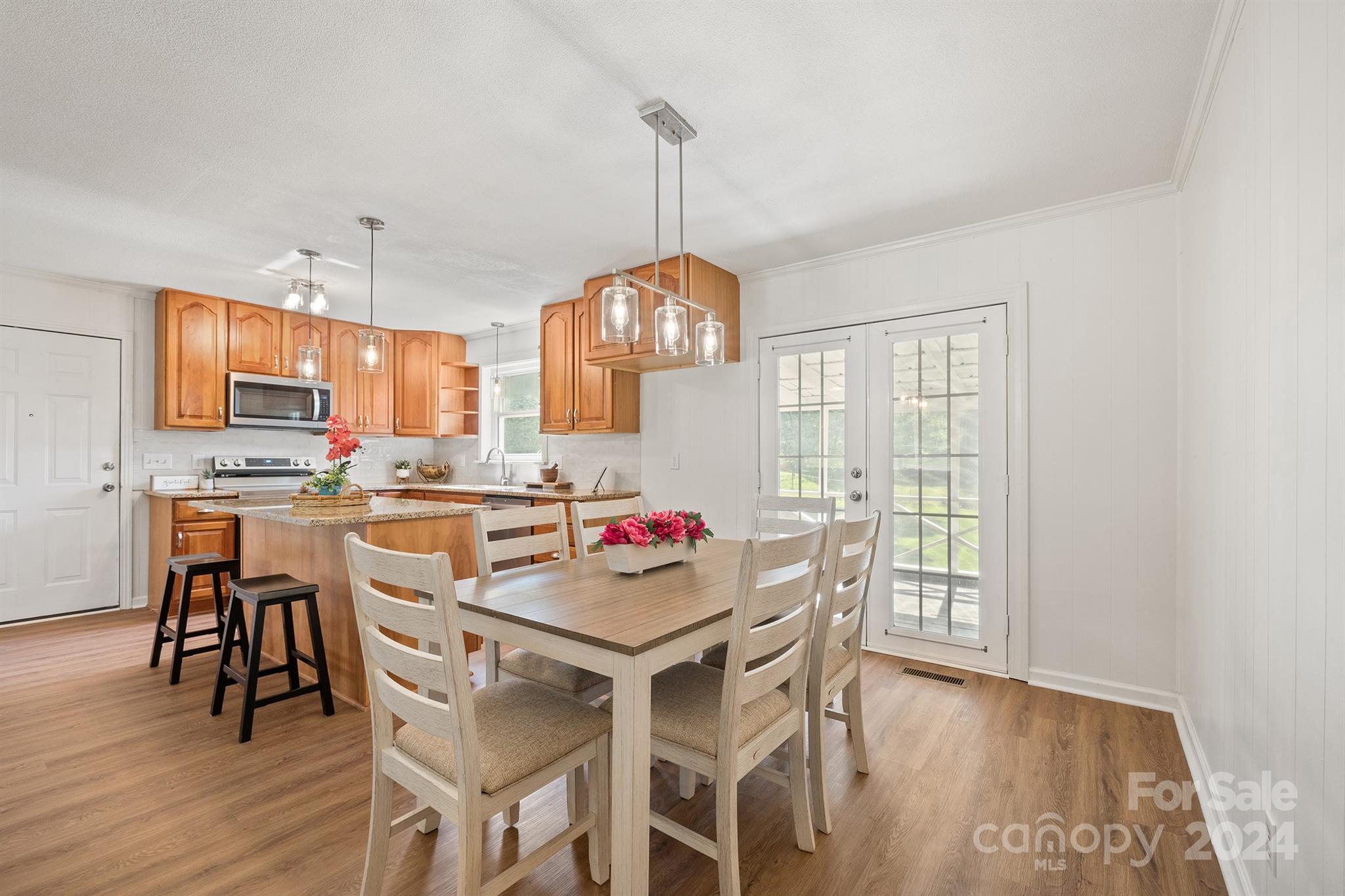 507 Shue Road China Grove, NC 28023 - Photo 15 of 34 a kitchen with a dining table chairs and white cabinets