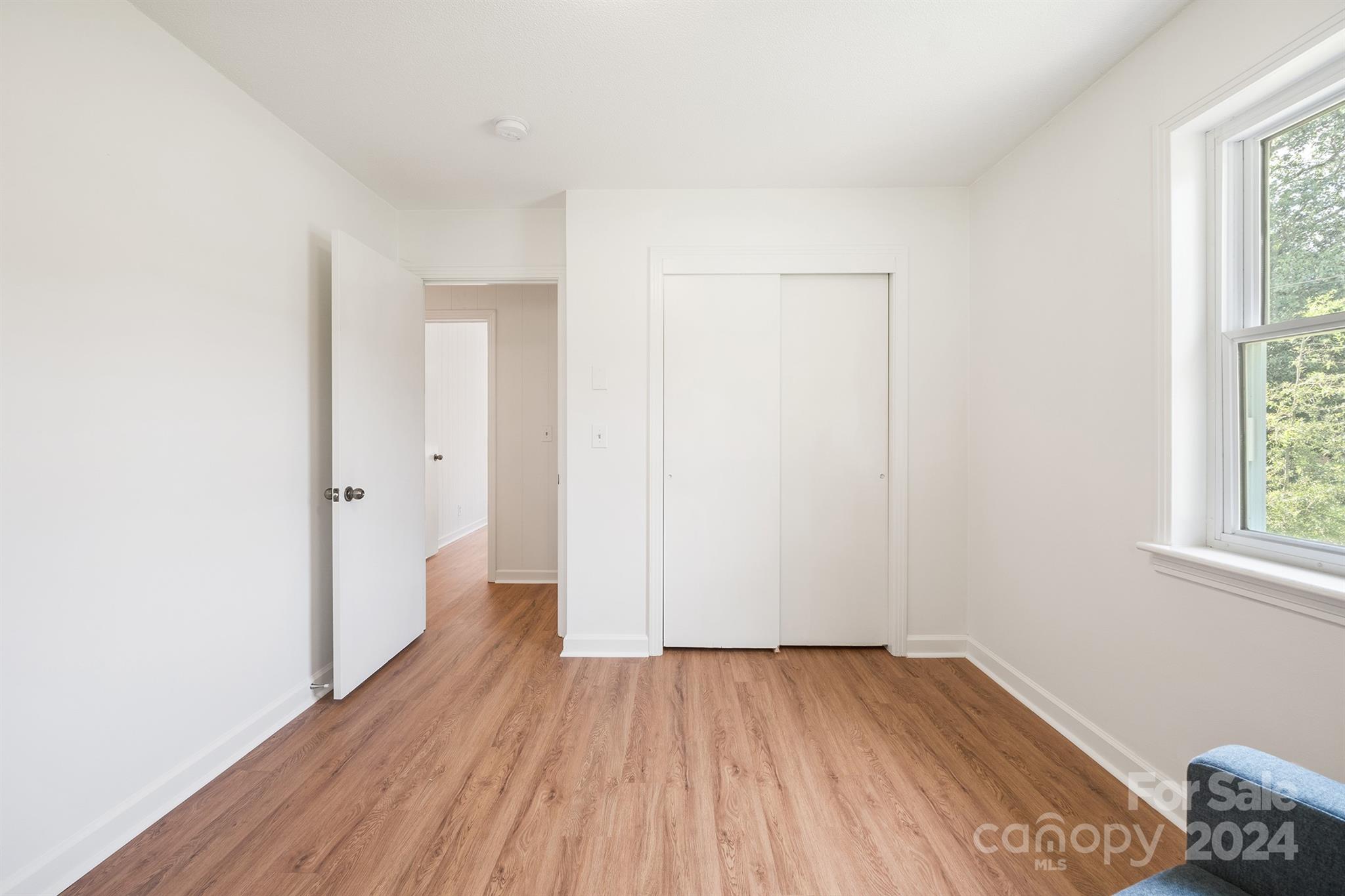 507 Shue Road China Grove, NC 28023 - Photo 22 of 34 an empty room with wooden floor and windows