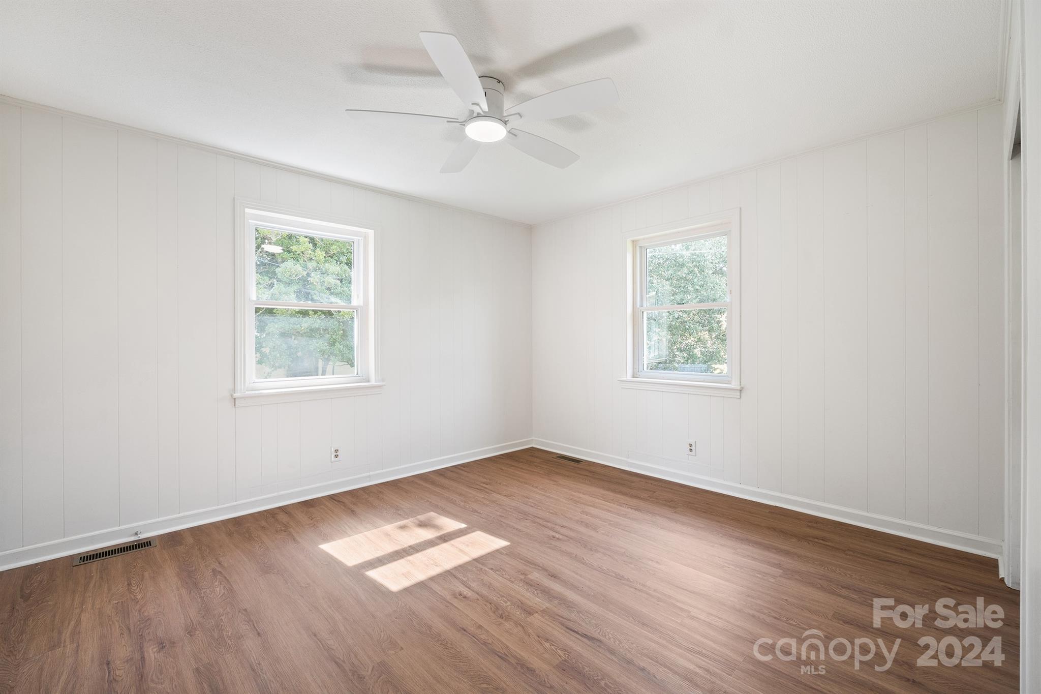 507 Shue Road China Grove, NC 28023 - Photo 23 of 34 an empty room with wooden floor and windows