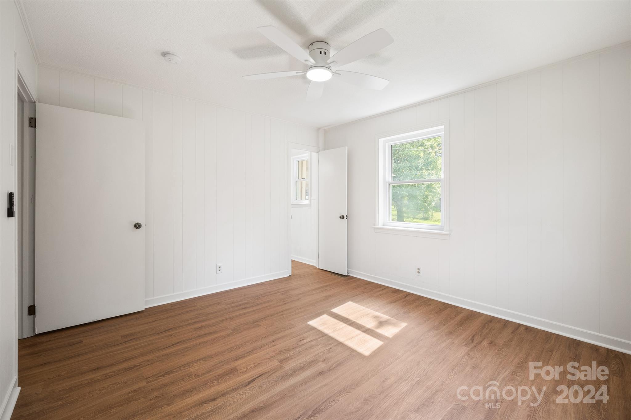 507 Shue Road China Grove, NC 28023 - Photo 25 of 34 an empty room with wooden floor ceiling fan and windows